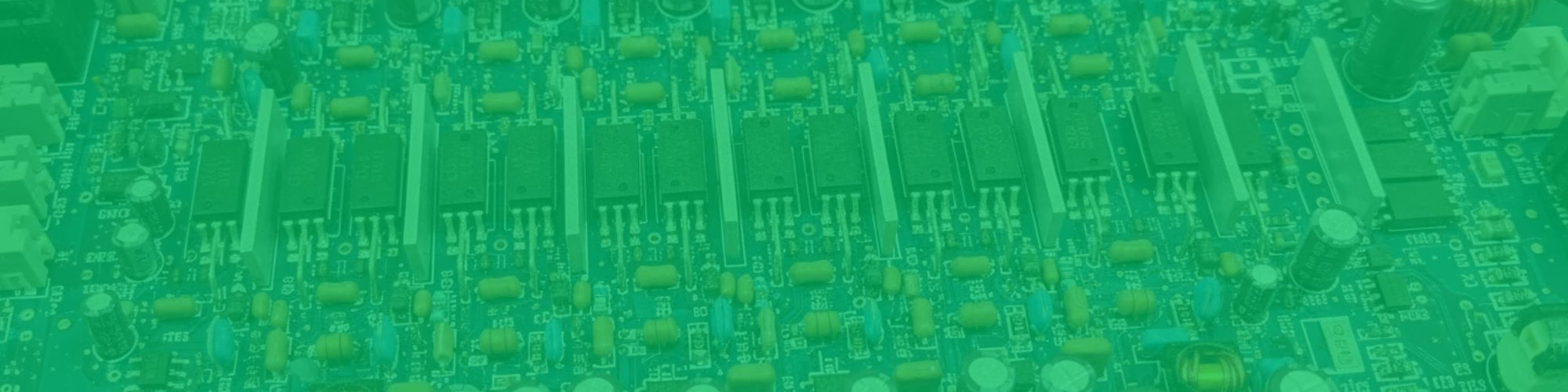 “Green-tinted close-up of an electronic circuit board with rows of components and heat sinks.”